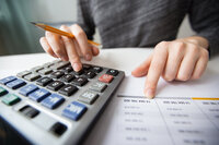 closeup-accountant-hands-counting-calculator